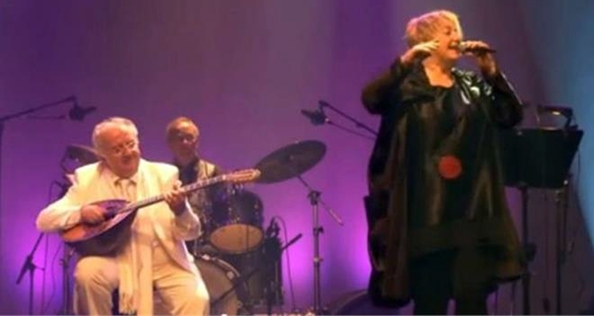 Η Αργυρώ Καπαρού και ο σολίστ του μπουζουκιού Παρασκευάς Γρεκής ενώ ερμηνεύουν τραγούδια στην παράσταση που αποτίνει φόρο τιμής στη Μελίνα Μερκούρη